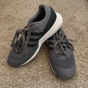 Grey Adidas tennis shoes.